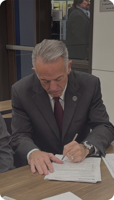 Governor Joe Lombardo signing important paperwork
